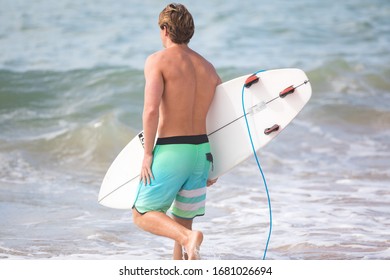 MANLY, NSW/AUSTRALIA – MARCH 2020: Young Adults Catching Waves Surfing At Manly Beach On A Bright Warm Sunny Day On Clear Blue Water