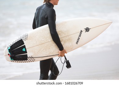 MANLY, NSW/AUSTRALIA – MARCH 2020: Young Adults Catching Waves Surfing At Manly Beach On A Bright Warm Sunny Day On Clear Blue Water