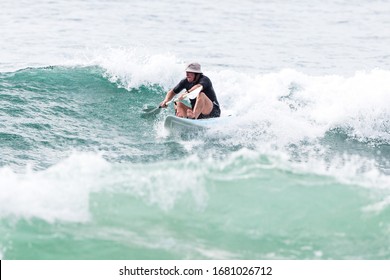 MANLY, NSW/AUSTRALIA – MARCH 2020: Young Adults Catching Waves Surfing At Manly Beach On A Bright Warm Sunny Day On Clear Blue Water