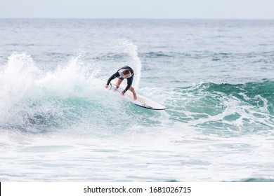 MANLY, NSW/AUSTRALIA – MARCH 2020: Young Adults Catching Waves Surfing At Manly Beach On A Bright Warm Sunny Day On Clear Blue Water