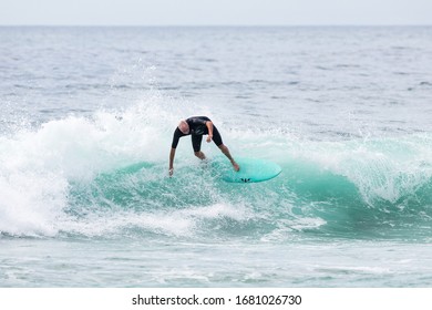 MANLY, NSW/AUSTRALIA – MARCH 2020: Young Adults Catching Waves Surfing At Manly Beach On A Bright Warm Sunny Day On Clear Blue Water