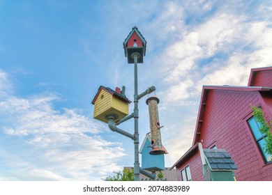 Manmade colorful bird nests on a pipe outside a house at Daybreak, Utah