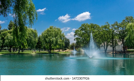Man-made lake surrounded by trees - Shutterstock ID 1472307926