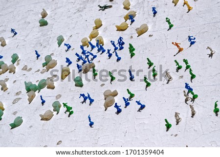 Man-made plastic manlike figures practising sports. Sports whistles made from plastic.