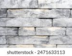 Manmade smooth cement blocks used in a new gray retaining wall, an abstract pattern background
