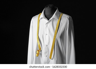 Mannequin With Custom Tailored Shirt And Measuring Tape On Dark Background