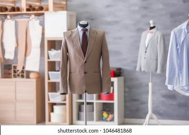 Mannequin with elegant suit in tailor's workshop