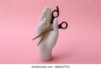 Mannequin Hand Holding Hair Scissors On Pink Background. Minimalism Beauty Concept