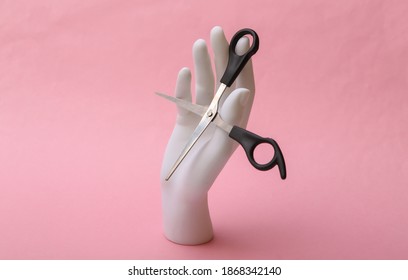 Mannequin Hand Holding Hair Scissors On Pink Background. Minimalism Beauty Concept