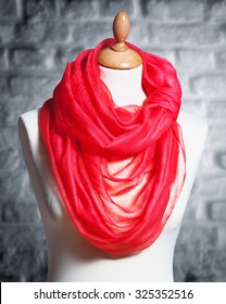 Mannequin with silk cloth. Knitted fashion red organza shawl on tailor bust