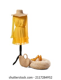 Mannequin With Stylish Dress, Hat, Wicker Bag And Ottoman With Shoes On White Background