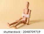 Mannequin with tied around rope on color background. Concept of hostage