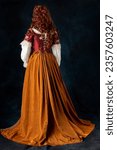 A mannequin wearing a red silk renaissance, Tudor, Georgian or fantasy style bodice and 