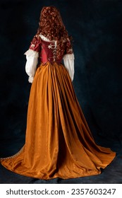 A mannequin wearing a red silk renaissance, Tudor, Georgian or fantasy style bodice and  - Shutterstock ID 2357603247