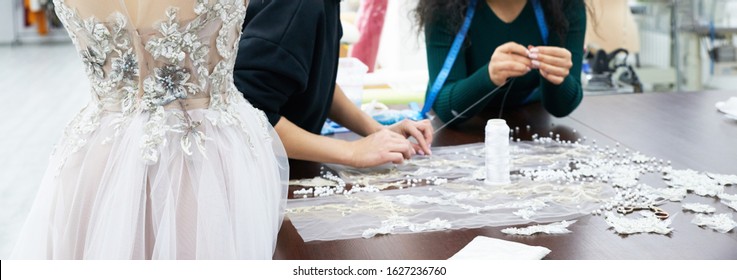 Mannequin With A Wedding Dress Is In The Tailor's Shop. Dressmaker Working In Atelier.