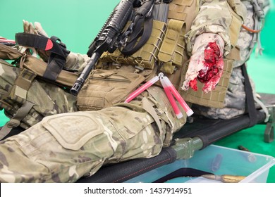 Mannequin Of A Wounded Fighter With A Severe Wound On A Stretcher. Medicine