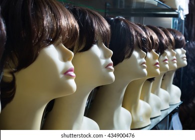 Mannequins With Brunet Style Wigs On Shelves Of Hair Salon 
