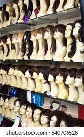 Mannequins With Colorful Wigs Types On Shelves Of Hair Salon 