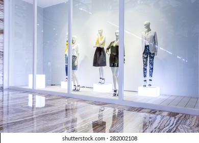 mannequins in fashion shop display window