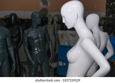 Mannequins Standing In An Empty Warehouse, Dark Background, Man Vs Woman