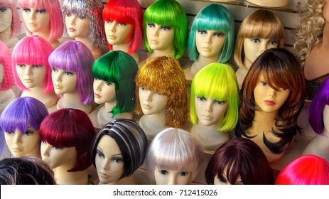 Mannequins Wearing Colorful Wigs In A Wig Shop Store Window