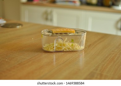 Mannheim, Germany - August 3, 2019 : Grated Parmesan Inside The Plastic Grater; The Rind Of Cheese Is Shown On Top