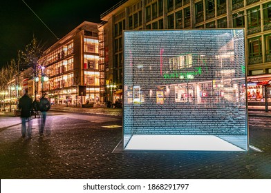 Mannheim, Germany. November 14th, 2009. Two People Walking At Night By The Mahnmal Memorial. Commemorative Sculpture For The Jewish Victims Of The Nazi Holocaust In Mannheim 