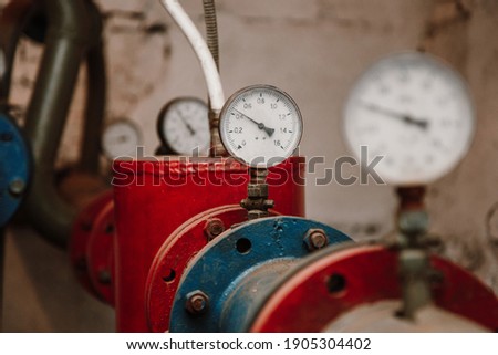 Manometers on pipes in the basement, heating system of an apartment building