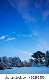 A Manor House In A Snowy Winter Landscape, With Big Blue Sky Overhead. Copyspace For Your Text/design.