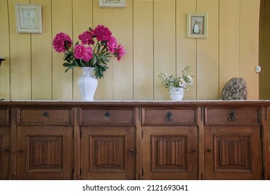 Manor Interior With Old Wooden Furniture And Vase Full Of Flowers. Latvia.