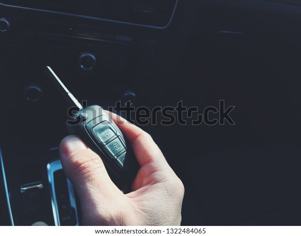 Mans arm holding modern car
key