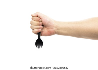 A Man's Arm Holds A Small Disposable Black Plastic Fork