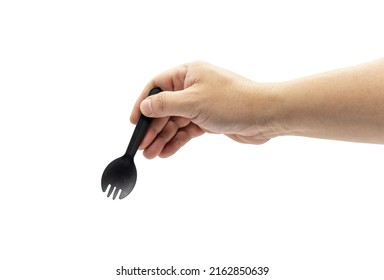 A Man's Arm Holds A Small Disposable Black Plastic Fork