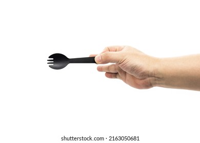 A Man's Arm Holds A Small Disposable Black Plastic Fork