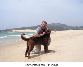 Man's Best Friend - Middle Aged Man On The Beach With His Dog