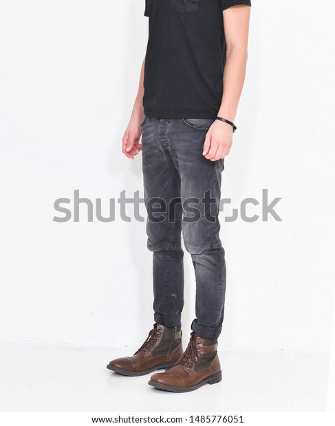 black shirt and brown jeans