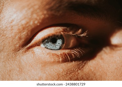 Man's blue eye close-up in the sun - Powered by Shutterstock