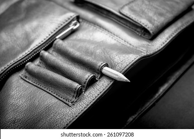 A Man's Business Briefcase Bag, Leather Satchel With A Pencil In Black And White