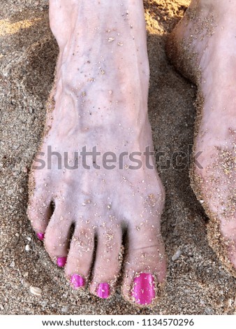 man's feet on the sand