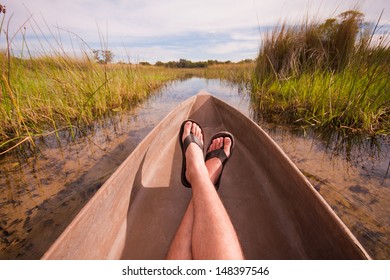 Mans Feet Relaxing A Canoe With An Interesting Point Of View