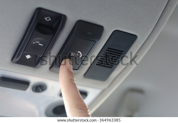 Man\'s finger pressing\
emergency sos button to contact with call center to ask for help\
after car accident