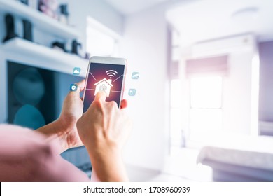 Man's Finger Touch The Icon On Smartphone Screen, Electronics Devices Connecting With Wireless. Smart Home Control And Automation System Technology Of Things