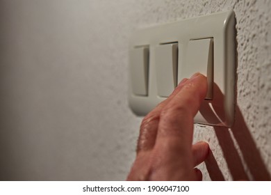 
Man's Fingers Operating The Light Switch