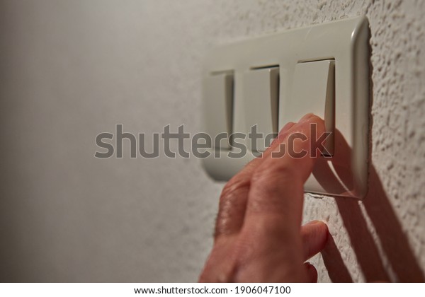 \
Man\'s fingers\
operating the light\
switch