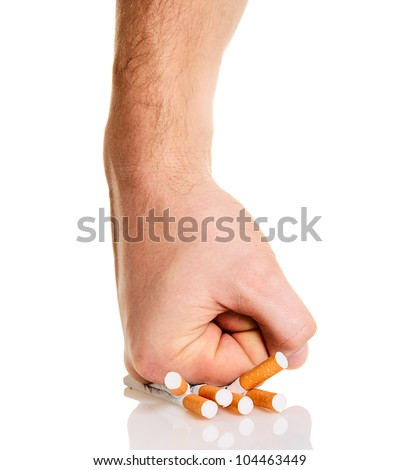 Man's fist crushing cigarettes isolated on white background
