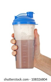 Man's Fist Holding The Post Workout Chocolate Whey Protein Shake, Ready To Drink It, Isolated On White