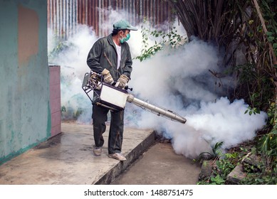 The man's fogging to eliminate mosquito for preventing spread dengue fever and prevent other diseases that have mosquitoes causing the disease
