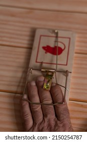 Man's Hand Caught In A Wooden Mouse Trap