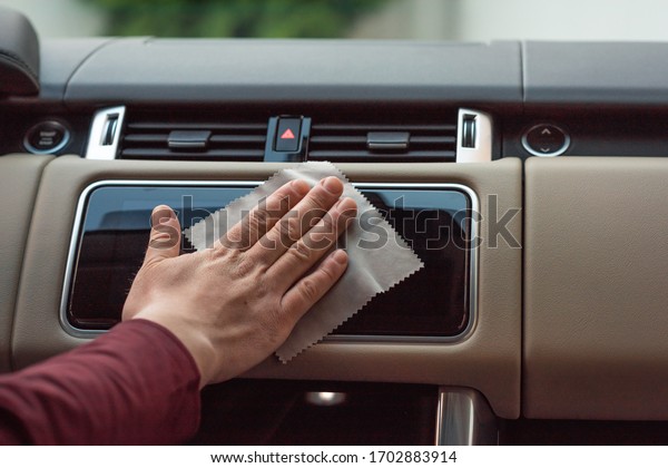 man\'s hand\
cleaning car interior, car detailing (or valeting) concept.\
Selective focus. Coronavirus, covid 19\

