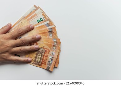 a man's hand close-up on a white background holds a hand spread out euros for 50. with the right there is a place for the inscription beautiful money background - Shutterstock ID 2194099345